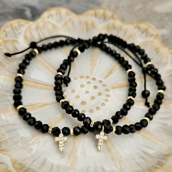 Descoperă frumusețea și eleganța discretă a acestei brățări cu cruciuliță și cristale negre, accesoriul perfect pentru femeile care iubesc combinația dintre stil modern și simboluri cu semnificație spirituală. [9]
