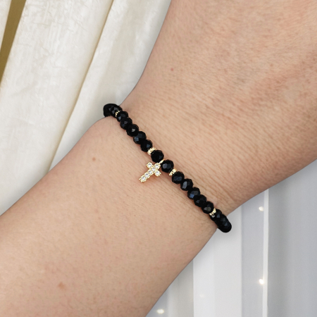 Bratari pentru EA - Descoperă frumusețea și eleganța discretă a acestei brățări cu cruciuliță și cristale negre, accesoriul perfect pentru femeile care iubesc combinația dintre stil modern și simboluri cu semnificație spirituală.