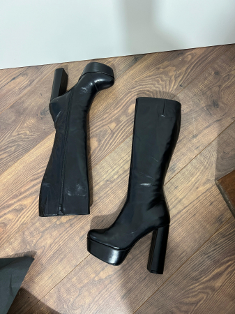 Cizme din piele naturala neagra. Aceste cizme au un toc gros de 12,5cm si un platou de 4 cm ce ofera stabilitate si confort in timpul mersului. [2]