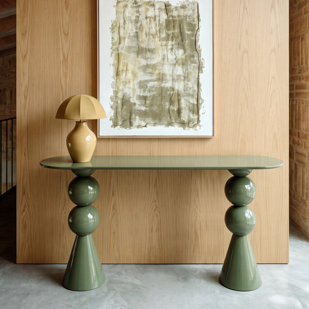 Stil de design - Consolă din metal verde salvie cu blat oval alungit și picioare din două sfere sub un tablou