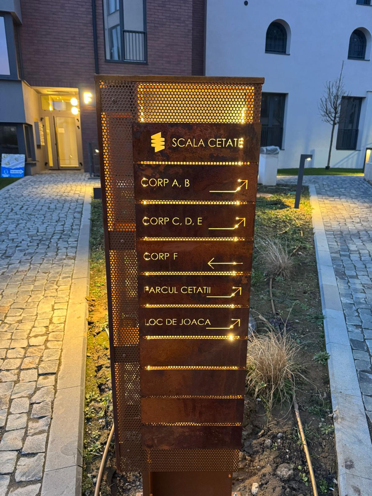Corten Steel and Perforated Metal Wayfinding Totem – Industrial Aesthetics and Long-Lasting Durability