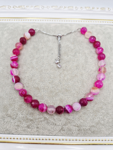 Set alcatuit din Colier realizat din Agate fucsia si inchizatoare reglabila care se potriveste unui catel de talie mica si Bratara pe elastic asortata pentru stapana catelului. [1]