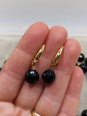 Set alcatuit din colier si cercei realizati din onix negru fatetat si sfere aurii din otel inoxidabil. Inchizatoare si tortite din cubic zirconia. [2]