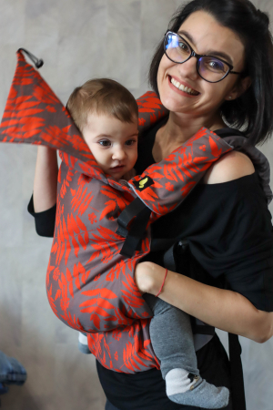Luna UNA (0-36 Luni) - Marsupiu ergonomic Luna Una editie limitata, purtat de un părinte cu bebeluș. Design ajustabil, bretele moi și glugă pentru susținerea capului.
