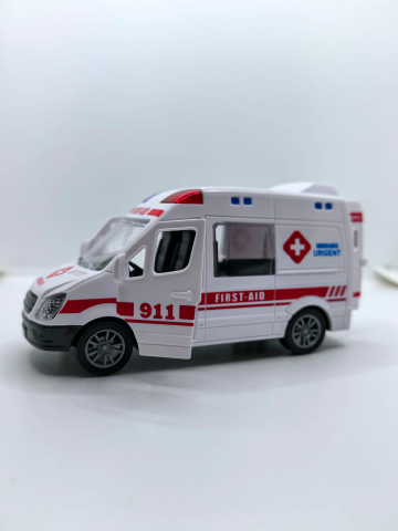 Mașinuță de jucărie ambulanță de culoare albă cu ușile din spate și portiera față deschise, inscripționată cu textul AMBULANCE URGENT.
