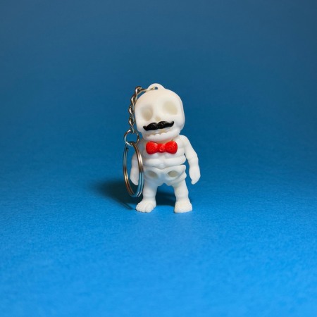 Figurine & Brelocuri Flexi - Scheletul cu Mustață și Papion – Eleganța Înfricoșătoare